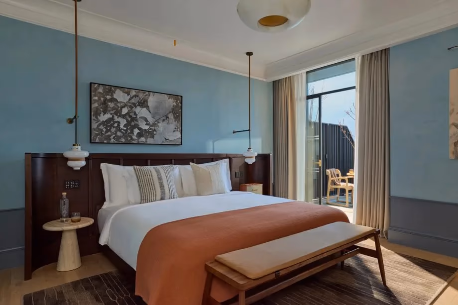 Hotel bedroom with blue walls and a balcony
